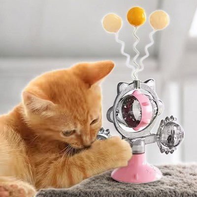 Chat mangeant avec distributeur WhirlCatFeeder rose