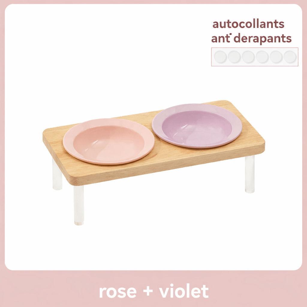 Gamelle surélevée pour chat MiaouTable, coloris rose et violet, avec support en bois et autocollants antidérapants.